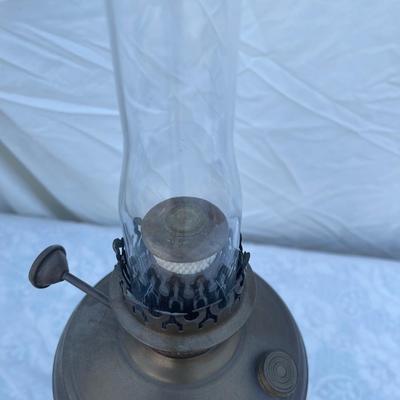Sale Photo Thumbnail #163: Antique Brass Oil Lamp with super skinny glass chimney. Chimney could seat better on the lamp, but otherwise the lamp is in good condition! Base is about 5" across, total height is about 21" including glass chimney.
