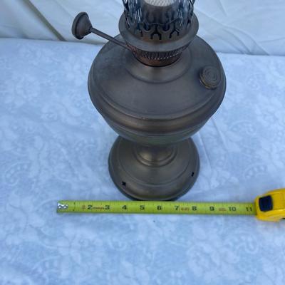 Sale Photo Thumbnail #165: Antique Brass Oil Lamp with super skinny glass chimney. Chimney could seat better on the lamp, but otherwise the lamp is in good condition! Base is about 5" across, total height is about 21" including glass chimney.