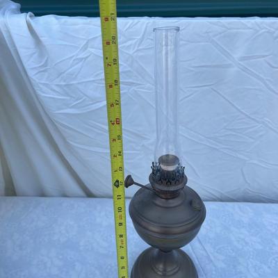 Sale Photo Thumbnail #166: Antique Brass Oil Lamp with super skinny glass chimney. Chimney could seat better on the lamp, but otherwise the lamp is in good condition! Base is about 5" across, total height is about 21" including glass chimney.
