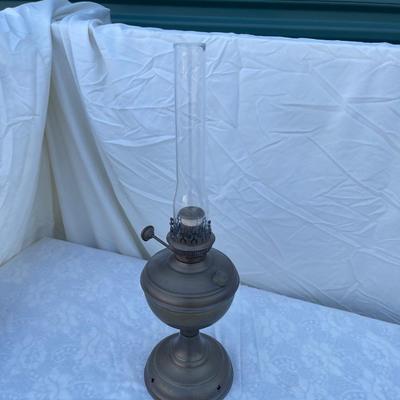 Sale Photo Thumbnail #162: Antique Brass Oil Lamp with super skinny glass chimney. Chimney could seat better on the lamp, but otherwise the lamp is in good condition! Base is about 5" across, total height is about 21" including glass chimney.
