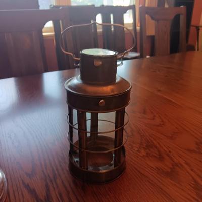 TALL GLASS OIL LAMP AND A CANDLE LANTERN