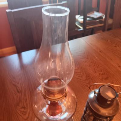 TALL GLASS OIL LAMP AND A CANDLE LANTERN