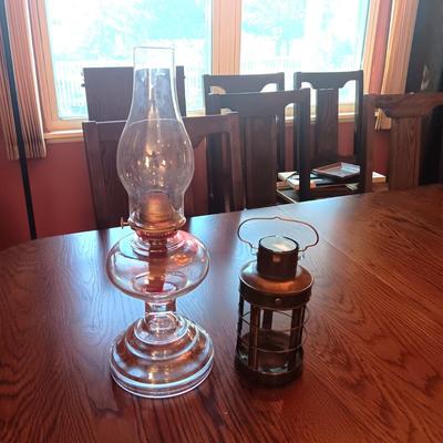 TALL GLASS OIL LAMP AND A CANDLE LANTERN