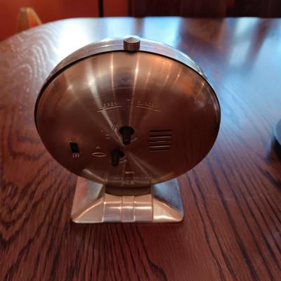 AN ART DECO STYLE ALARM CLOCK AND AN HOUR GLASS