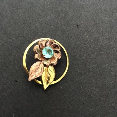 Gold tone rose, gold tone, lapel pin with aqua blue rhinestone