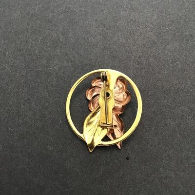 Gold tone rose, gold tone, lapel pin with aqua blue rhinestone