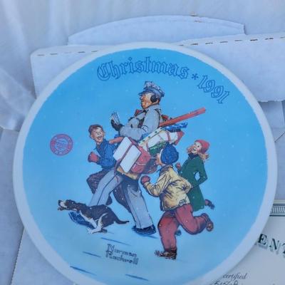 Sale Photo Thumbnail #209: It was produced on fine china by the Edwin M Knowles China Company. 
The plate has a diameter of 8-1/4 inches. 
It features a festive scene of a man dressed as Santa's Helper with children and a dog. 
This plate is considered a collectible item, often fou