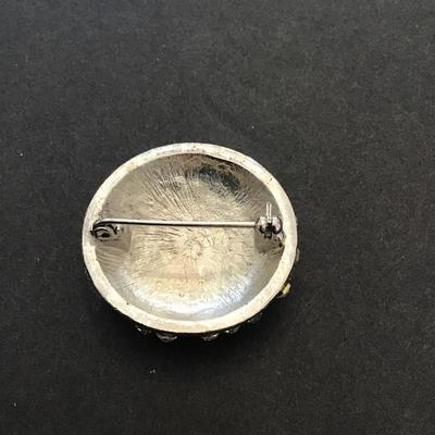 Silver tone brooch with clear rhinestones