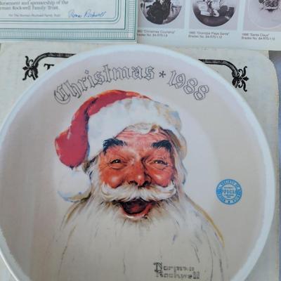 Sale Photo Thumbnail #216: Christmas 1988". 
Artist: Norman Rockwell, known for his American cultural depictions.
Manufacturer: Edwin M Knowles China.
Year of Issue: 1988, as indicated on the plate.