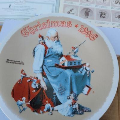 Sale Photo Thumbnail #229: Manufacturer: Knowles China.
Year: 1998.
Title: "Santa's Helpers".
Collectibility: It is a limited edition collector's plate and often comes with a certificate of authenticity, as seen in the imag