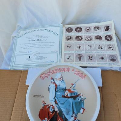 Sale Photo Thumbnail #231: Manufacturer: Knowles China.
Year: 1998.
Title: "Santa's Helpers".
Collectibility: It is a limited edition collector's plate and often comes with a certificate of authenticity, as seen in the imag