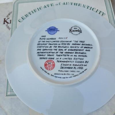 Sale Photo Thumbnail #250: It is the 20th plate in an annual series of Christmas plates by Norman Rockwell. 
It is a hand-numbered, limited edition plate certified by the Rockwell Society of America and produced by Knowles China.