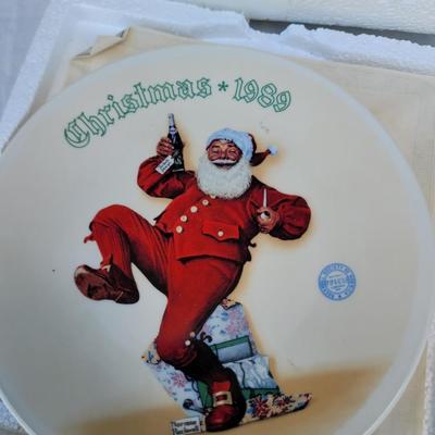 Sale Photo Thumbnail #339: vintage Norman Rockwell Christmas collector's plate from 1989, specifically featuring a depiction of Santa Claus, likely part of a series like "Jolly Old St. Nick" or a similar Christmas theme. 
Artist and Series:
The plate features artwork by renowned Am