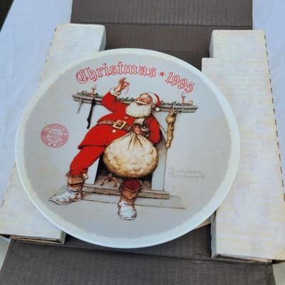 Sale Photo Thumbnail #341: Norman Rockwell "Filling The Stocking" collector plate from the 1995 Christmas series by Knowles. 
It is a limited edition plate, originally painted by Norman Rockwell in 1975, and certified by the Rockwell Society of America. 
The plate is part of an ann