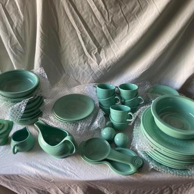 Sale Photo Thumbnail #450: Complete Fiestaware Set, 49 pieces total. 8 place settings including dinner plate, side plate, bowl, cup, and saucer for each. Also includes salt and pepper shakers, trivet, gravy boat, 2 condiment containers, and spoon rest. All in good condition.