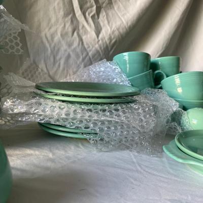 Sale Photo Thumbnail #452: Complete Fiestaware Set, 49 pieces total. 8 place settings including dinner plate, side plate, bowl, cup, and saucer for each. Also includes salt and pepper shakers, trivet, gravy boat, 2 condiment containers, and spoon rest. All in good condition.