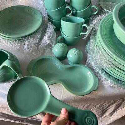 Sale Photo Thumbnail #453: Complete Fiestaware Set, 49 pieces total. 8 place settings including dinner plate, side plate, bowl, cup, and saucer for each. Also includes salt and pepper shakers, trivet, gravy boat, 2 condiment containers, and spoon rest. All in good condition.
