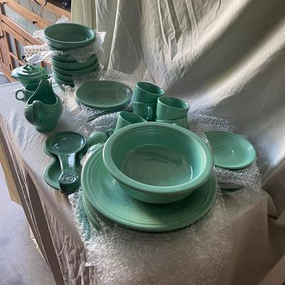 Sale Photo Thumbnail #456: Complete Fiestaware Set, 49 pieces total. 8 place settings including dinner plate, side plate, bowl, cup, and saucer for each. Also includes salt and pepper shakers, trivet, gravy boat, 2 condiment containers, and spoon rest. All in good condition.