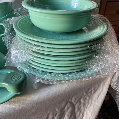 Sale Photo Thumbnail #454: Complete Fiestaware Set, 49 pieces total. 8 place settings including dinner plate, side plate, bowl, cup, and saucer for each. Also includes salt and pepper shakers, trivet, gravy boat, 2 condiment containers, and spoon rest. All in good condition.