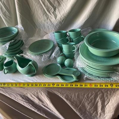 Sale Photo Thumbnail #457: Complete Fiestaware Set, 49 pieces total. 8 place settings including dinner plate, side plate, bowl, cup, and saucer for each. Also includes salt and pepper shakers, trivet, gravy boat, 2 condiment containers, and spoon rest. All in good condition.