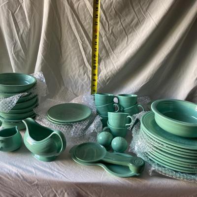 Sale Photo Thumbnail #458: Complete Fiestaware Set, 49 pieces total. 8 place settings including dinner plate, side plate, bowl, cup, and saucer for each. Also includes salt and pepper shakers, trivet, gravy boat, 2 condiment containers, and spoon rest. All in good condition.