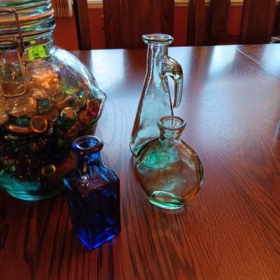 A COLLECTION OF GLASS BOTTLES AND LARGE JAR MADE IN ITALY