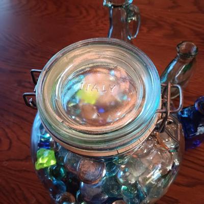 A COLLECTION OF GLASS BOTTLES AND LARGE JAR MADE IN ITALY