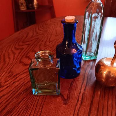 GLASS BOTTLES AND BRASS DECOR
