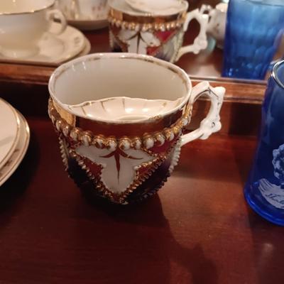 SHIRLEY TEMPLE AND MUSTACHE CUPS PLUS TEACUPS AND SAUCERS