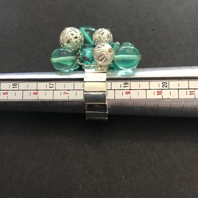 Very nice silver toned stretchy ring with plastic and silver beads