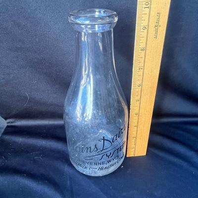 Sale Photo Thumbnail #632: This is a RARE bottle!!  Plains Dairy predominantly used square bottles!  The round ones are very hard to find.