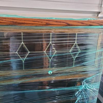 Sale Photo Thumbnail #607: I've left this one wrapped and will wrap it more for transport and for the buyer to view. It's in perfect condition, doors open upwards and slide in, top is leaded glass, measures 60" tall, 33" wide and 12" deep. There is am earlier matching one up for au