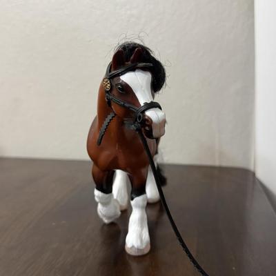 Two Breyer model horses and 1 other.