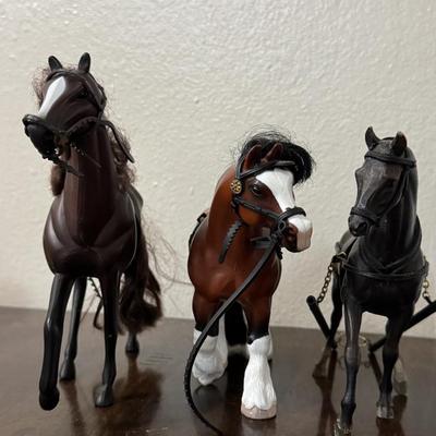 Two Breyer model horses and 1 other.