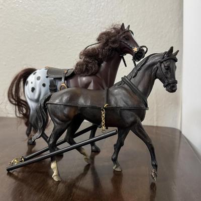 Two Breyer model horses and 1 other.