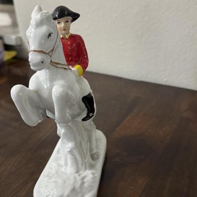 Porcelain Lipizzaner horse. A couple sitting on a bench.