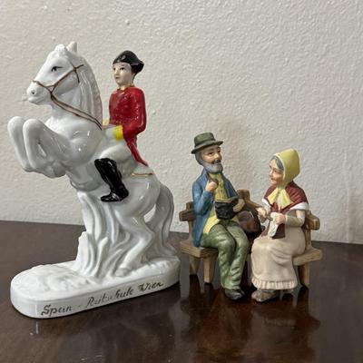 Porcelain Lipizzaner horse. A couple sitting on a bench.