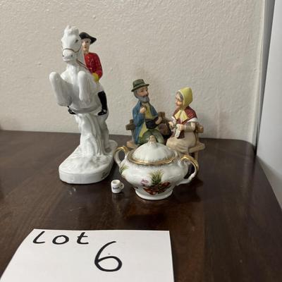 Porcelain Lipizzaner horse. A couple sitting on a bench.