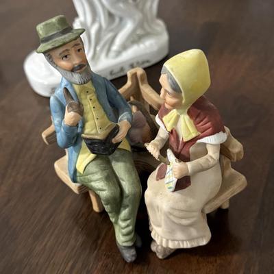 Porcelain Lipizzaner horse. A couple sitting on a bench.
