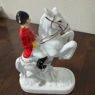 Porcelain Lipizzaner horse. A couple sitting on a bench.