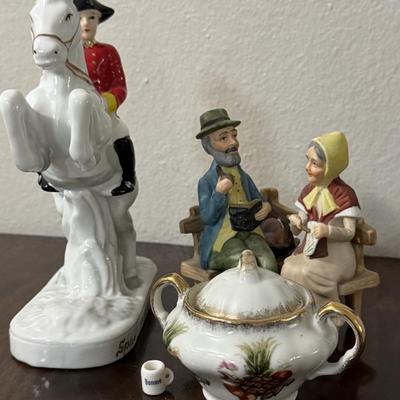 Porcelain Lipizzaner horse. A couple sitting on a bench.