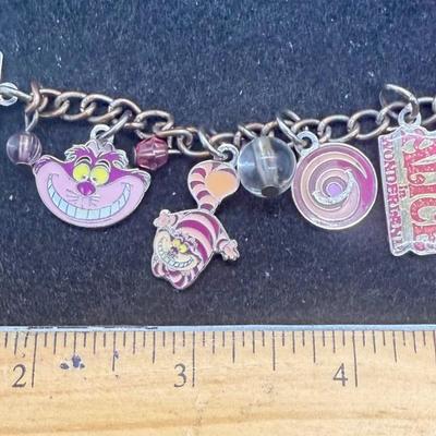 Sale Photo Thumbnail #433: Silvertone 4” chain with several attached charms. NOTE: this is not a charm bracelet, rather it is a short chain with charms.