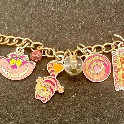 Sale Photo Thumbnail #430: Silvertone 4” chain with several attached charms. NOTE: this is not a charm bracelet, rather it is a short chain with charms.