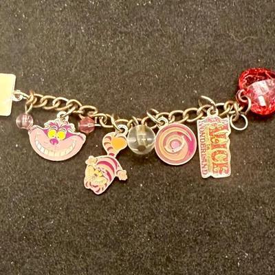 Sale Photo Thumbnail #429: Silvertone 4” chain with several attached charms. NOTE: this is not a charm bracelet, rather it is a short chain with charms.