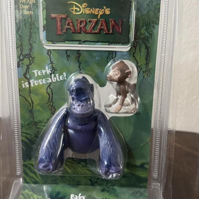 Disney Tarzan figures and Ronald McDonald toy.