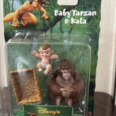 Disney Tarzan figures and Ronald McDonald toy.