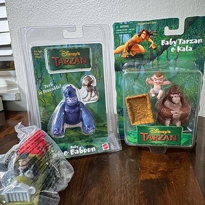 Disney Tarzan figures and Ronald McDonald toy.