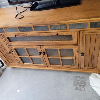 Sale Photo Thumbnail #658: In perfect condition, tv does not come with it. 62" wide, 20" deep and 36" tall, glass has rain pattern, super nice piece.
