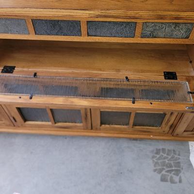 Sale Photo Thumbnail #665: In perfect condition, tv does not come with it. 62" wide, 20" deep and 36" tall, glass has rain pattern, super nice piece.