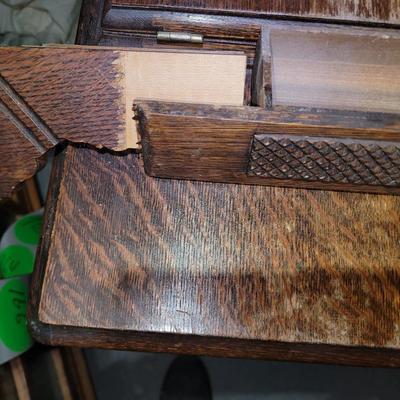 Sale Photo Thumbnail #791: Antique Singer Sewing Machine Table Plus Sewing Accoutrements (Lot of 4). Sewing machine with original table and foot pedal, cast iron and wood details. Also includes folding wooden box of different sewing feet, Singer buttonhole making foot, and pin cush